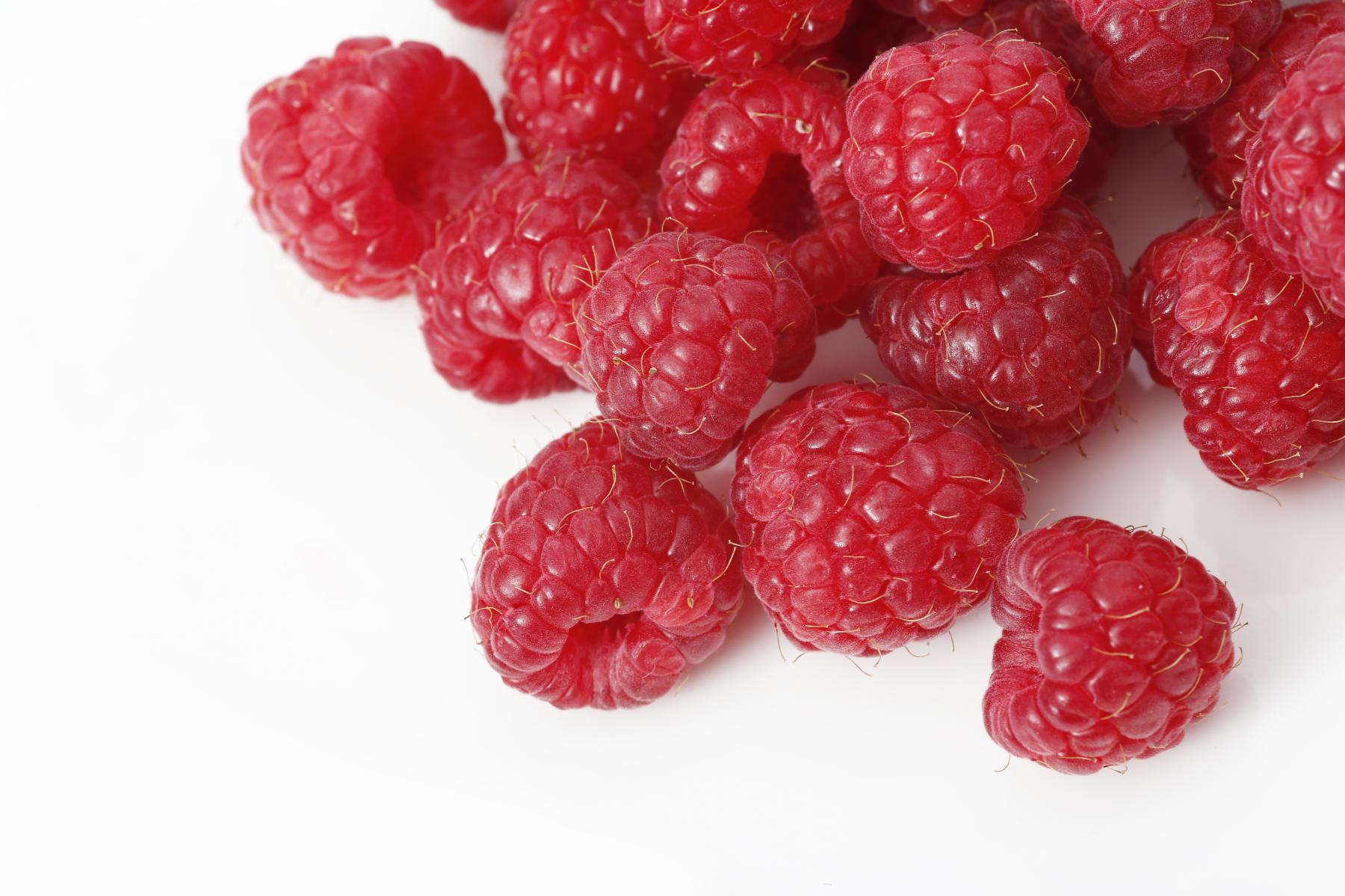 Mehrere frische rote Himbeeren auf weißem Hintergrund