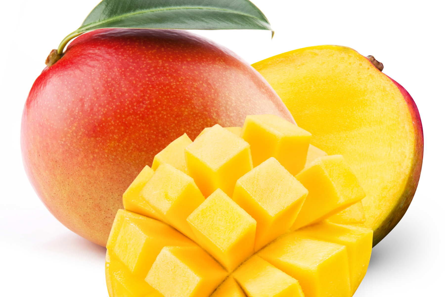 Ganze, reife Mango mit roter und gelber Schale, eine Hälfte mit grünem Blatt, eine Hälfte aufgeschnitten, daneben gewürfelte Mango