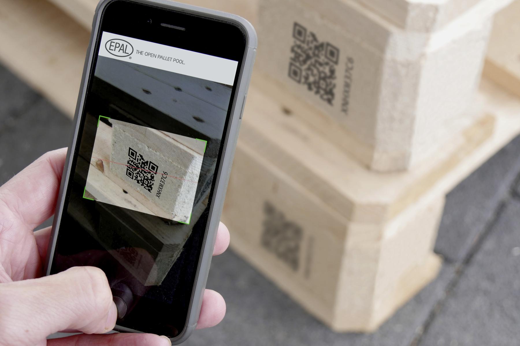 Mit Smartphone wird QR-Code auf Palette gescannt