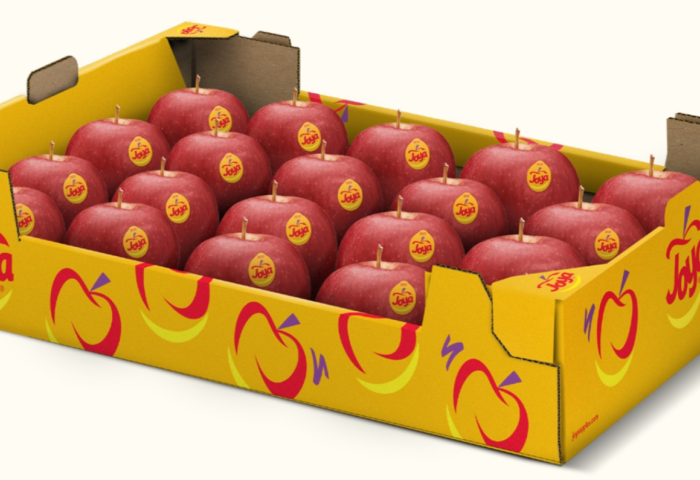 Gelbe Obstkiste mit 18 roten Äpfeln, jeder mit rundem gelben Aufkleber 'Joya' und stilisiertem Apfelmotiv
