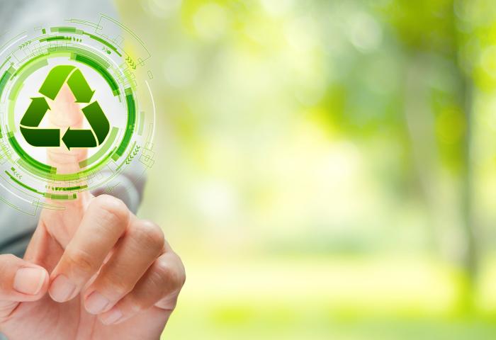 Finger tippt auf Recycling-Zeichen