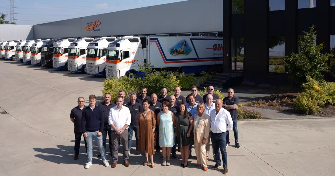 Das gesamte Team von GEMEX steht draußen vor einer Reihe LKWs